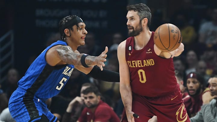 Dec 2, 2022; Cleveland, Ohio, USA; Orlando Magic forward Paolo Banchero (5) defends Cleveland Cavaliers forward Kevin Love (0) during the first half at Rocket Mortgage FieldHouse. Mandatory Credit: Ken Blaze-Imagn Images