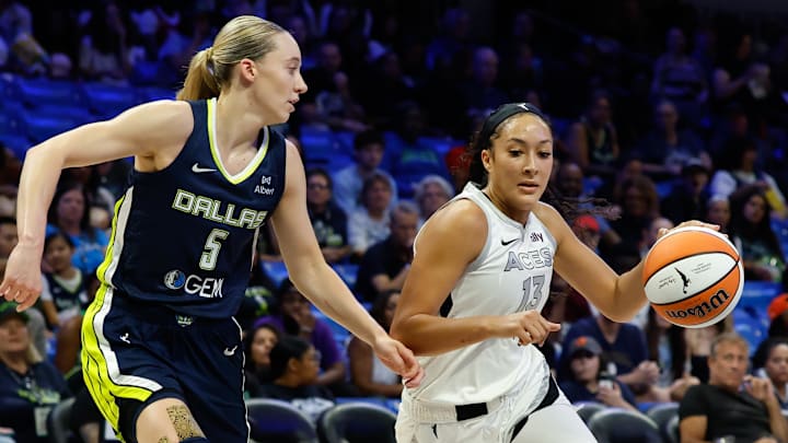 Jul 16, 2025; Arlington, Texas, USA;  Las Vegas Aces guard Aaliyah Nye (13) drives to the basket as Dallas Wings guard Paige Bueckers (5) defends during the first half at College Park Center. Mandatory Credit: Chris Jones-Imagn Images