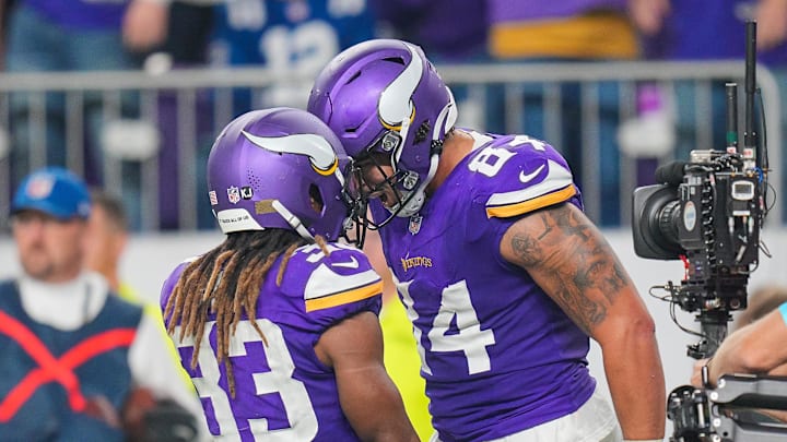 Nov 3, 2024; Minneapolis, Minnesota, USA; Minnesota Vikings tight end Josh Oliver (84) celebrates his touchdown with wide receiver Jalen Nailor (83) against the Indianapolis Colts in the fourth quarter at U.S. Bank Stadium. Mandatory Credit: Brad Rempel-Imagn Images