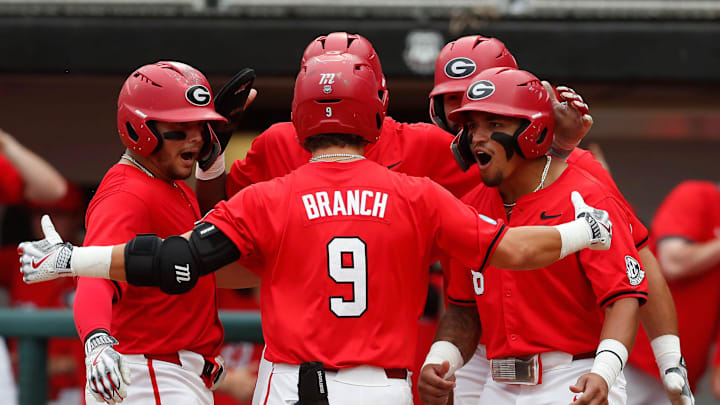 Georgia's Kolby Branch (9) celebrates with his teammates after hitting a grand slam during a NCAA Athens Regional baseball game against UNCW in Athens, Ga., on Saturday, June 1, 2024.