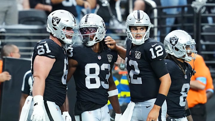 Oct 13, 2024; Paradise, Nevada, USA; Las Vegas Raiders wide receiver Kristian Wilkerson (83) celebrates with guard Jordan Meredith (61) and quarterback Aidan O'Connell (12) after scoring a touchdown against the Pittsburgh Steelers during the fourth quarter at Allegiant Stadium. Mandatory Credit: Stephen R. Sylvanie-Imagn Images