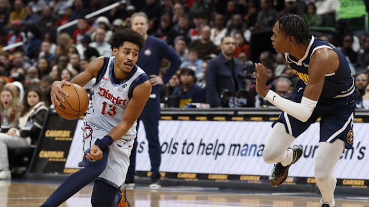Dec 7, 2024; Washington, District of Columbia, USA; Washington Wizards guard Jordan Poole (13) dribbles the ball as Denver Nuggets forward Peyton Watson (8) defends in the fourth quarter at Capital One Arena. Mandatory Credit: Geoff Burke-Imagn Images