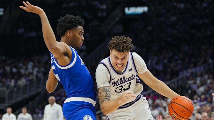 Dec 17, 2024; Kansas City, Missouri, USA; Kansas State Wildcats guard Coleman Hawkins (33) drives against Drake Bulldogs guard Tavion Banks (6) at T-Mobile Center. Mandatory Credit: Jay Biggerstaff-Imagn Images Dec 17, 2024; Kansas City, Missouri, USA; Kansas State Wildcats guard Coleman Hawkins (33) drives against Drake Bulldogs guard Tavion Banks (6) at T-Mobile Center. Mandatory Credit: Jay Biggerstaff-Imagn Images
