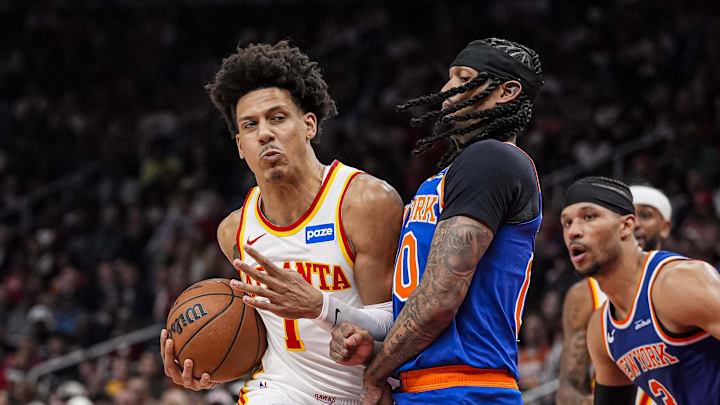 Apr 25, 2026; Atlanta, Georgia, USA; Atlanta Hawks forward Jalen Johnson (1) truest get to the basket defended by New York Knicks guard Jordan Clarkson (00) during the second half during game four of the first round of the 2026 NBA Playoffs at State Farm Arena. Mandatory Credit: Dale Zanine-Imagn Images