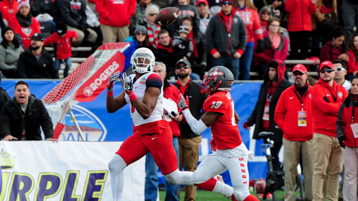 Dec 19, 2015; Albuquerque, NM, USA; Arizona Wildcats wide receiver Cayleb Jones (1) matches a catch for a first down as New Mexico Lobos cornerback Nias Martin (19) defends durign the first half in the 2015 New Mexico Bowl at University Stadium. Mandatory Credit: Matt Kartozian-Imagn Images