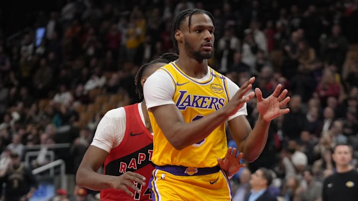 Nov 1, 2024; Toronto, Ontario, CAN; Los Angeles Lakers guard Bronny James (9) looks for a pass as Toronto Raptors guard Ja'Kobe Walter (14) defends during the second half at Scotiabank Arena. Mandatory Credit: John E. Sokolowski-Imagn Images