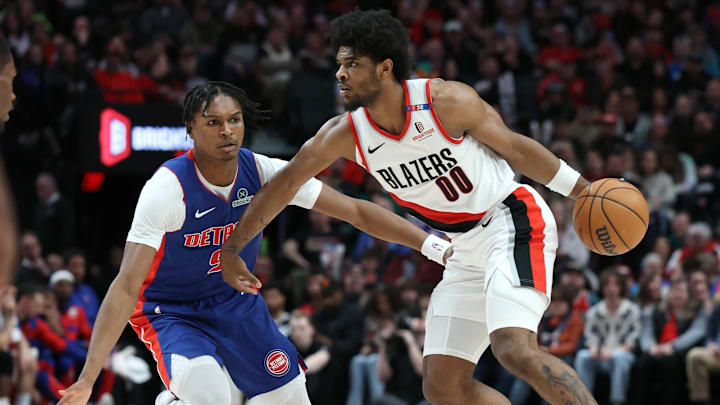 Mar 9, 2025; Portland, Oregon, USA; Portland Trail Blazers guard Scoot Henderson (00) dribbles the ball past Detroit Pistons forward Ausar Thompson (9) in the first half at Moda Center. Mandatory Credit: Jaime Valdez-Imagn Images