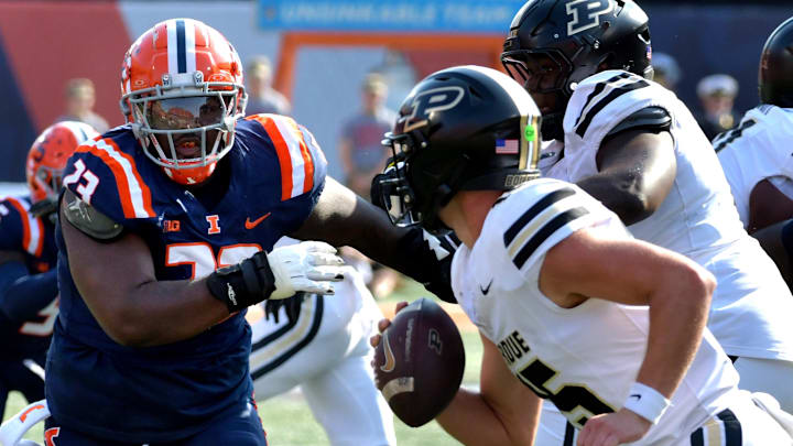 Oct 12, 2024; Champaign, Illinois, USA;  Illinois Fighting Illini defensive lineman Terah Edwards (23) pursues Purdue Boilermakers quarterback Ryan Browne (15) with the ball in the first half at Memorial Stadium. Mandatory Credit: Ron Johnson-Imagn Images