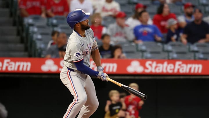 Sep 28, 2024; Anaheim, California, USA;  Texas Rangers second baseman Marcus Semien (2) hits a double during the first inning against the Los Angeles Angels at Angel Stadium. Mandatory Credit: Kiyoshi Mio-Imagn Images