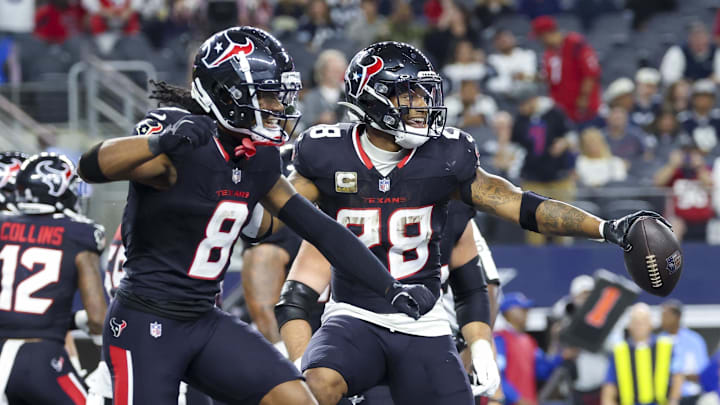Nov 18, 2024; Arlington, Texas, USA; Houston Texans running back Joe Mixon (28) celebrates with Houston Texans wide receiver John Metchie III (8) after scoring a touchdown during the second half against the Dallas Cowboys at AT&T Stadium. Mandatory Credit: Kevin Jairaj-Imagn Images