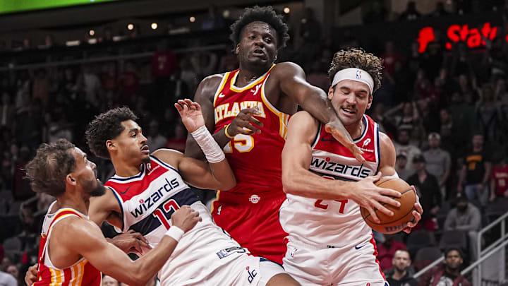 Oct 28, 2024; Atlanta, Georgia, USA; Washington Wizards guard Jordan Poole (13) and forward Corey Kispert (24) fight for a rebound with Atlanta Hawks guard Trae Young (11) and center Clint Capela (15) during the second half at State Farm Arena. Mandatory Credit: Dale Zanine-Imagn Images