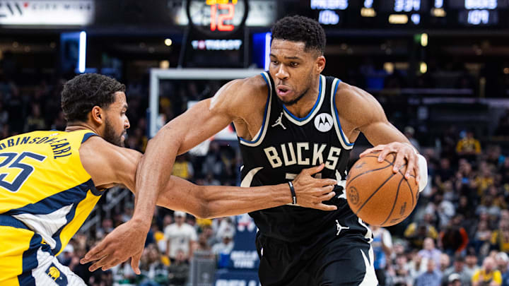 Nov 3, 2025; Indianapolis, Indiana, USA; Milwaukee Bucks forward Giannis Antetokounmpo (34) dribbles the ball while  Indiana Pacers forward Jeremiah Robinson-Earl (25) defends in the second half at Gainbridge Fieldhouse. Mandatory Credit: Trevor Ruszkowski-Imagn Images