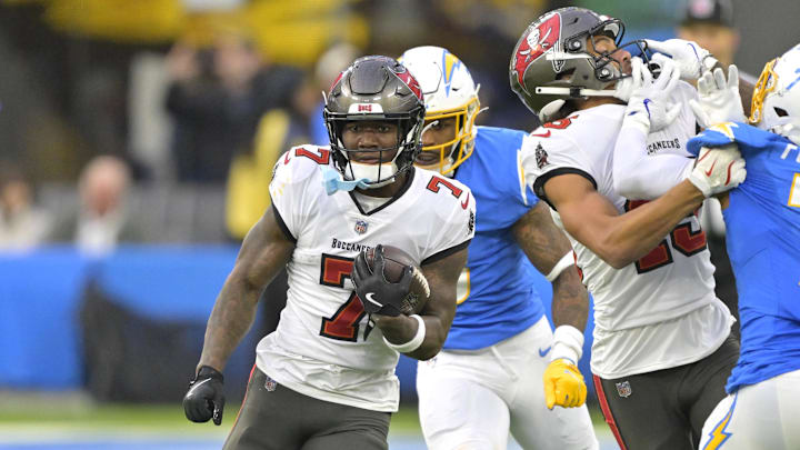 Dec 15, 2024; Inglewood, California, USA; Tampa Bay Buccaneers running back Bucky Irving (7) runs the ball for a first down in the second half against the Los Angeles Chargers at SoFi Stadium. Dec 15, 2024; Inglewood, California, USA; Tampa Bay Buccaneers running back Bucky Irving (7) runs the ball for a first down in the second half against the Los Angeles Chargers at SoFi Stadium.
