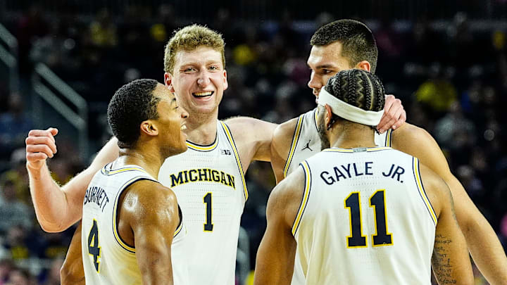 From left, Michigan guard Nimari Burnett (4), center Danny Wolf (1), center Vladislav Goldin (50) and guard Roddy Gayle Jr. (11) celebrate a play against Oregon during the second half at Crisler Center in Ann Arbor on Wednesday, Feb. 5, 2025.