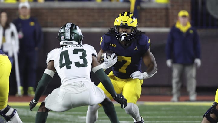 Oct 26, 2024; Ann Arbor, Michigan, USA;  Michigan Wolverines running back Donovan Edwards (7) rushes at Michigan State Spartans defensive back Malik Spencer (43) in the first half at Michigan Stadium. Mandatory Credit: Rick Osentoski-Imagn Images