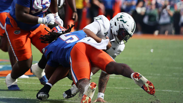 Sep 6, 2025; Gainesville, Florida, USA; Florida Gators linebacker Myles Graham (5) tackles South Florida Bulls quarterback Byrum Brown (17) during the first quarter at Ben Hill Griffin Stadium. Mandatory Credit: Kim Klement Neitzel-Imagn Images