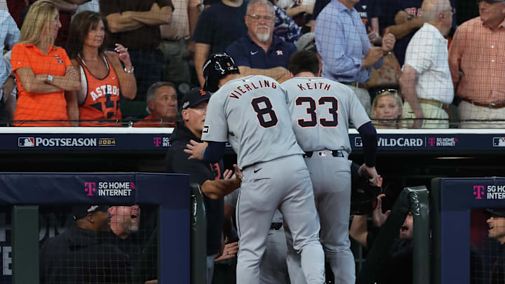 Oct 2, 2024; Houston, Texas, USA; Detroit Tigers outfielder Matt Vierling (8) and second base Colt Keith (33) celebrate with manager A.J. Hinch (left) after scoring against the Houston Astros during the eighth inning of game two of the Wildcard round for the 2024 MLB Playoffs at Minute Maid Park.