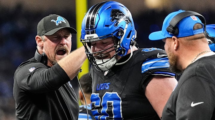 Detroit Lions head coach Dan Campbell talks to guard Graham Glasgow (60) after a play against Buffalo Bills during the first half at Ford Field in Detroit on Sunday, Dec. 15, 2024.