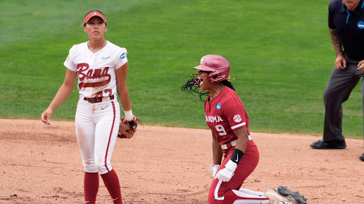 Oklahoma utility Tia Milloy (9) celebrates beside Alabama infielder Salen Hawkins (47) after stealing second base in the third inning of Game 2 of an NCAA super regional between the University of Oklahoma (OU) and the Alabama Crimson Tide at Love's Field in Norman, Saturday, May 24, 2025.