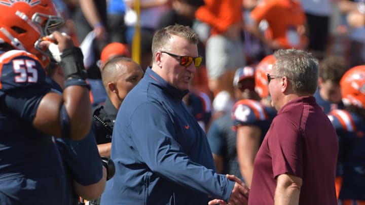 Sep 14, 2024; Champaign, Illinois, USA;  Illinois Fighting Illini head coach Bret Bielema shakes hands with head coach Jim McElwain  (right) after a game at Memorial Stadium. Mandatory Credit: Ron Johnson-Imagn Images