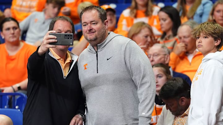 A Tennessee fan takes a photos with Tennessee football coach Josh Heupel at the NCAA Tournament Elite Eight game between Tennessee and Houston at Lucas Oil Stadium in Indianapolis, Ind., on Sunday, March 30, 2025.