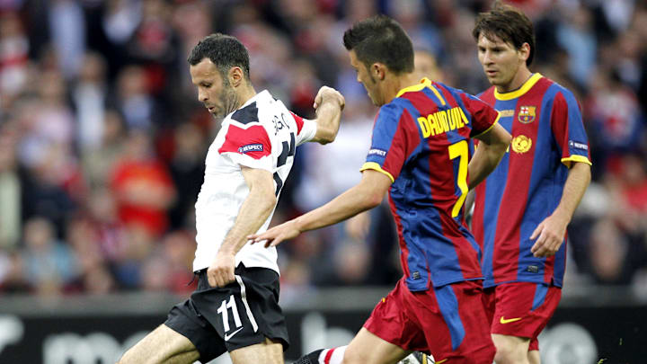 May 28, 2011; London, ENGLAND; Manchester United player Ryan Giggs (left) keeps the ball away from FC Barcelona players David Villa (middle) and Lionel Messi during the 2011 UEFA Champions League final at Wembley Stadium. Mandatory Credit: Walter Luger/GEPA via Imagn Images