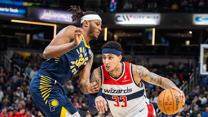 Jan 10, 2024; Indianapolis, Indiana, USA; Washington Wizards forward Kyle Kuzma (33) dribbles the ball while Indiana Pacers center Myles Turner (33) defends in the first half at Gainbridge Fieldhouse. Mandatory Credit: Trevor Ruszkowski-Imagn Images