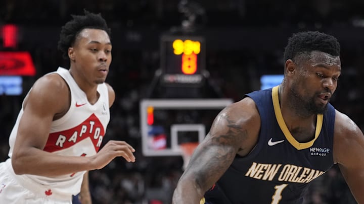 New Orleans Pelicans forward Zion Williamson drives to the net past Toronto Raptors forward Scottie Barnes.
