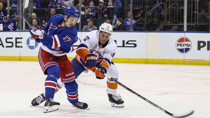 Sep 22, 2026; New York, New York, USA;  New York Rangers right wing Eeli Tolvanen (17) and New York Islanders defenseman Kashawn Aitcheson (37) battle for control of the puck in the second period at Madison Square Garden.  Mandatory Credit: Wendell Cruz-Imagn Images