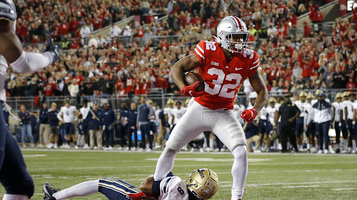 Sep 25, 2021; Columbus, Ohio, USA; Ohio State Buckeyes running back TreVeyon Henderson (32) runs in the touchdown over Akron Zips safety Jaylen Kelly-Powell (8)during the first quarter at Ohio Stadium. Mandatory Credit: Joseph Maiorana-USA TODAY Sports