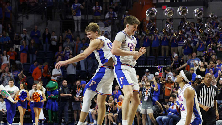 Jan 6, 2026; Gainesville, Florida, USA; Florida Gators forward Thomas Haugh (10) and forward Alex Condon (21) celebrate the win over the Georgia Bulldogs at Exactech Arena at the Stephen C. O'Connell Center. Mandatory Credit: Morgan Tencza-Imagn Images