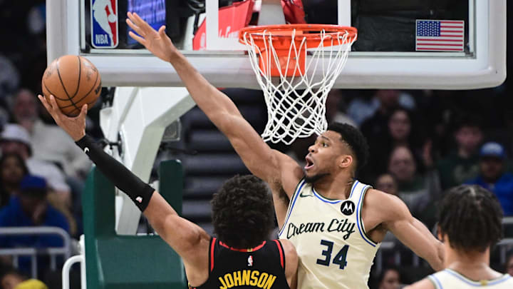 Mar 4, 2026; Milwaukee, Wisconsin, USA; Milwaukee Bucks forward Giannis Antetokounmpo (34) tries to block a shot by Atlanta Hawks forward Jalen Johnson (1) in the second quarter at Fiserv Forum. Mandatory Credit: Benny Sieu-Imagn Images