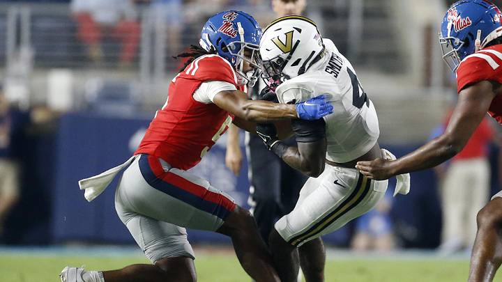 Vanderbilt Commodores running back Patrick Smith runs the ball as Mississippi Rebels defensive back John Saunders Jr. makes the tackle during the second half Vanderbilt Commodores running back Patrick Smith runs the ball as Mississippi Rebels defensive back John Saunders Jr. makes the tackle during the second half
