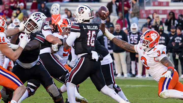 Nov 29, 2025; Columbia, South Carolina, USA; South Carolina Gamecocks quarterback Lanorris Sellers (16) passes under pressure from Clemson Tigers defensive end T.J. Parker (3) in the fourth quarter at Williams-Brice Stadium. Mandatory Credit: Jeff Blake-Imagn Images Nov 29, 2025; Columbia, South Carolina, USA; South Carolina Gamecocks quarterback Lanorris Sellers (16) passes under pressure from Clemson Tigers defensive end T.J. Parker (3) in the fourth quarter at Williams-Brice Stadium. Mandatory Credit: Jeff Blake-Imagn Images