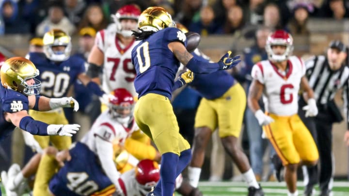 Oct 14, 2023; South Bend, Indiana, USA; Notre Dame Fighting Irish safety Xavier Watts (0) intercepts a pass in the second quarter against the USC Trojans at Notre Dame Stadium. Oct 14, 2023; South Bend, Indiana, USA; Notre Dame Fighting Irish safety Xavier Watts (0) intercepts a pass in the second quarter against the USC Trojans at Notre Dame Stadium.