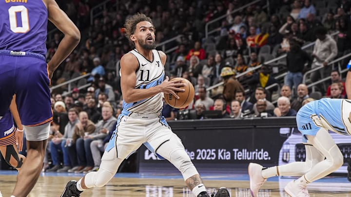 Jan 14, 2025; Atlanta, Georgia, USA; Atlanta Hawks guard Trae Young (11) drives to the basket against the Phoenix Suns during the first half at State Farm Arena. Mandatory Credit: Dale Zanine-Imagn Images