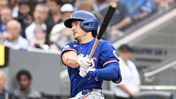 Jun 26, 2026; Toronto, Ontario, CAN;  Texas Rangers designated hitter Justin Foscue (14) hits an RBI single against the Toronto Blue Jays in the first inning at Rogers Centre. Mandatory Credit: Dan Hamilton-Imagn Images