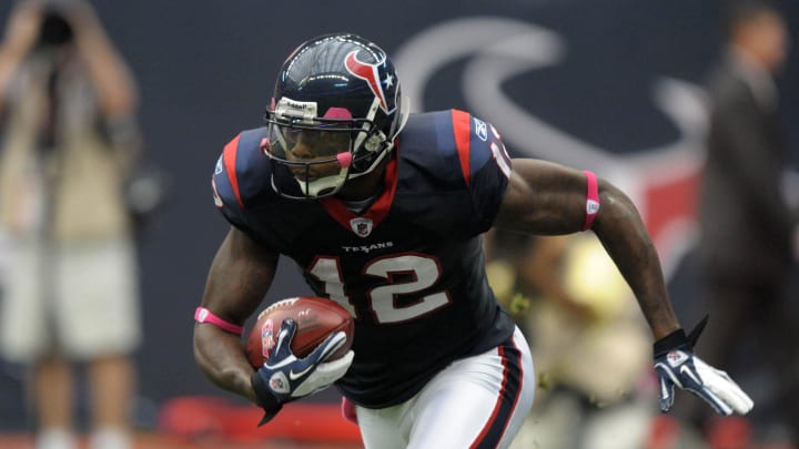 Oct 9, 2011; Houston, TX, USA; Houston Texans receiver Jacoby Jones (12) carries a ball with a NFL pink breast cancer awareness logo during the game against the Oakland Raiders at Reliant Stadium. The Raiders defeated the Texans 25-20. Mandatory Credit: Kirby Lee/Image of Sport-USA TODAY Sports