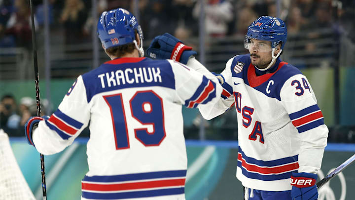 Feb 12, 2026; Milan, Italy;  Auston Matthews of United States celebrates scoring their fifth goal with Matthew Tkachuk of United States against Latvia in men's ice hockey group C play during the Milano Cortina 2026 Olympic Winter Games at Milano Santagiulia Ice Hockey Arena. Mandatory Credit: Geoff Burke-Imagn Images