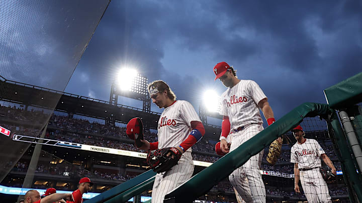 May 3, 2025; Philadelphia, Pennsylvania, USA; Philadelphia Phillies second base Bryson Stott (5) and first base Bryce Harper (3) enter the dugout between the fifth inning at Citizens Bank Park. 