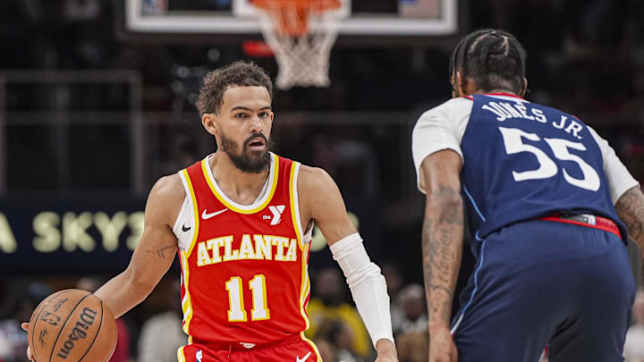 Mar 14, 2025; Atlanta, Georgia, USA; Atlanta Hawks guard Trae Young (11) dribbles against LA Clippers forward Derrick Jones Jr. (55) during the first half at State Farm Arena. Mandatory Credit: Dale Zanine-Imagn Images