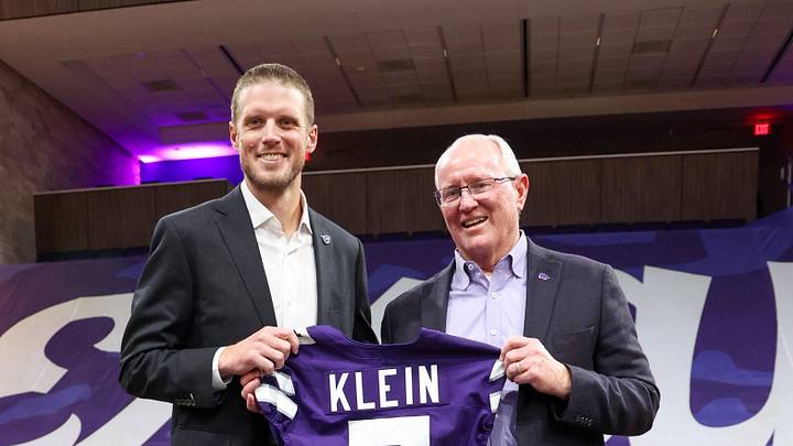 Dec 5, 2025; Manhattan, Kansas, USA; Collin Klein and athletic director Gene Taylor hold a jersey after Klein was named the new head coach of the Kansas State Wildcats football team at Morgan Family Arena. Mandatory Credit: Scott Sewell-Imagn Images Dec 5, 2025; Manhattan, Kansas, USA; Collin Klein and athletic director Gene Taylor hold a jersey after Klein was named the new head coach of the Kansas State Wildcats football team at Morgan Family Arena. Mandatory Credit: Scott Sewell-Imagn Images