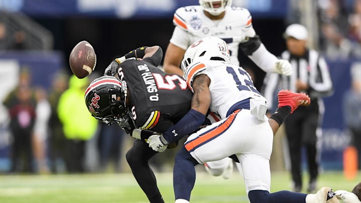 Dec 30, 2023; Nashville, TN, USA; Auburn Tigers safety Caleb Wooden (12) causes the fumble of Maryland Terrapins wide receiver Octavian Smith Jr. (5) during the first half at Nissan Stadium. Mandatory Credit: Steve Roberts-USA TODAY Sports