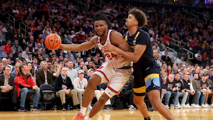 Mar 14, 2025; New York, NY, USA; St. John's Red Storm forward Zuby Ejiofor (24) drives to the basket against Marquette Golden Eagles forward Royce Parham (13) during the second half at Madison Square Garden. Mandatory Credit: Brad Penner-Imagn Images