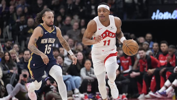 Jan 27, 2025; Toronto, Ontario, CAN; Toronto Raptors guard Bruce Brown (11) dribbles up court as New Orleans Pelicans guard Jose Alvarado (15) pursues during the first half at Scotiabank Arena. Mandatory Credit: John E. Sokolowski-Imagn Images