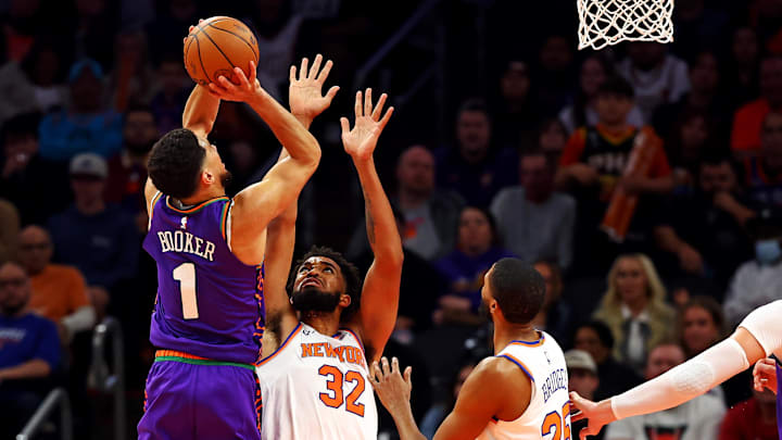 Nov 20, 2024; Phoenix, Arizona, USA; Phoenix Suns guard Devin Booker (1) shoots the ball against New York Knicks center Karl-Anthony Towns (32) during the third quarter at Footprint Center. Mandatory Credit: Mark J. Rebilas-Imagn Images Nov 20, 2024; Phoenix, Arizona, USA; Phoenix Suns guard Devin Booker (1) shoots the ball against New York Knicks center Karl-Anthony Towns (32) during the third quarter at Footprint Center. Mandatory Credit: Mark J. Rebilas-Imagn Images