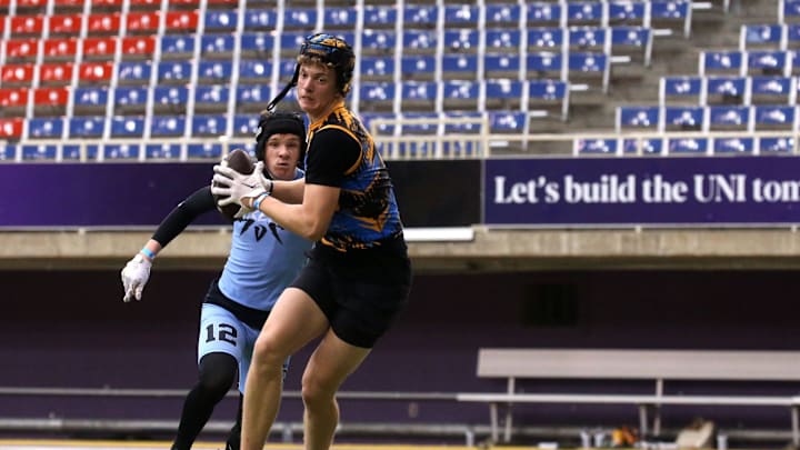 The Carroll Chargers’ Jaxx DeJean (9) turns to run after catching a pass during a 7-on-7 football tournament Saturday, April 13, 2024 at the UNI Dome in Cedar Falls, Iowa.