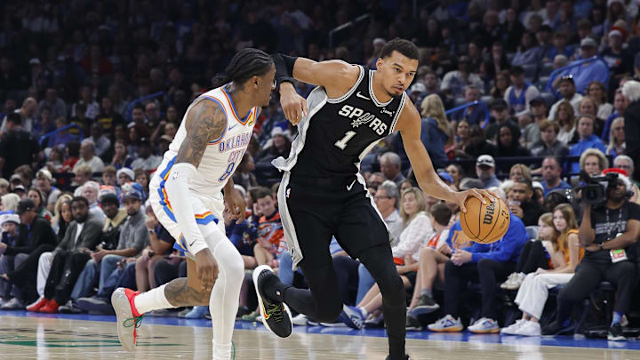 Dec 25, 2025; Oklahoma City, Oklahoma, USA; San Antonio Spurs forward Victor Wembanyama (1) drives down the court beside Oklahoma City Thunder guard Jalen Williams (8) during the second quarter at Paycom Center. Mandatory Credit: Alonzo Adams-Imagn Images Dec 25, 2025; Oklahoma City, Oklahoma, USA; San Antonio Spurs forward Victor Wembanyama (1) drives down the court beside Oklahoma City Thunder guard Jalen Williams (8) during the second quarter at Paycom Center. Mandatory Credit: Alonzo Adams-Imagn Images