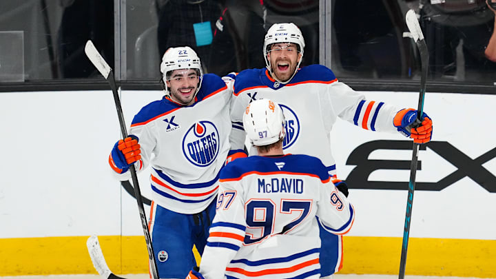 Mar 26, 2026; Las Vegas, Nevada, USA; Edmonton Oilers defenseman Evan Bouchard (2) celebrates with center Matt Savoie (22) and center Connor McDavid (97) after scoring a goal during an overtime period to give the Oilers a 4-3 victory over the Vegas Golden Knights at T-Mobile Arena. Mandatory Credit: Stephen R. Sylvanie-Imagn Images