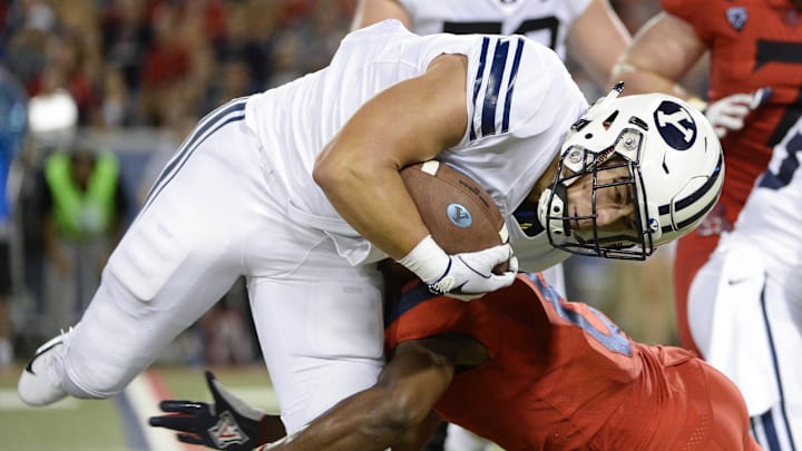 Sep 1, 2018; Tucson, AZ, USA; Brigham Young Cougars running back Lopini Katoa (4) is tackled by Arizona Wildcats cornerback Tim Hough (8) during the second half at Arizona Stadium. Mandatory Credit: Casey Sapio-Imagn Images